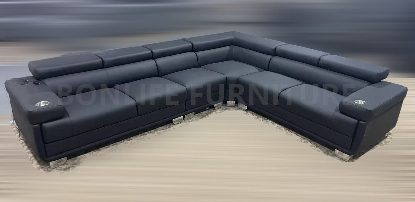 Front view black PU leather reversible sectional sofa in modern living room
