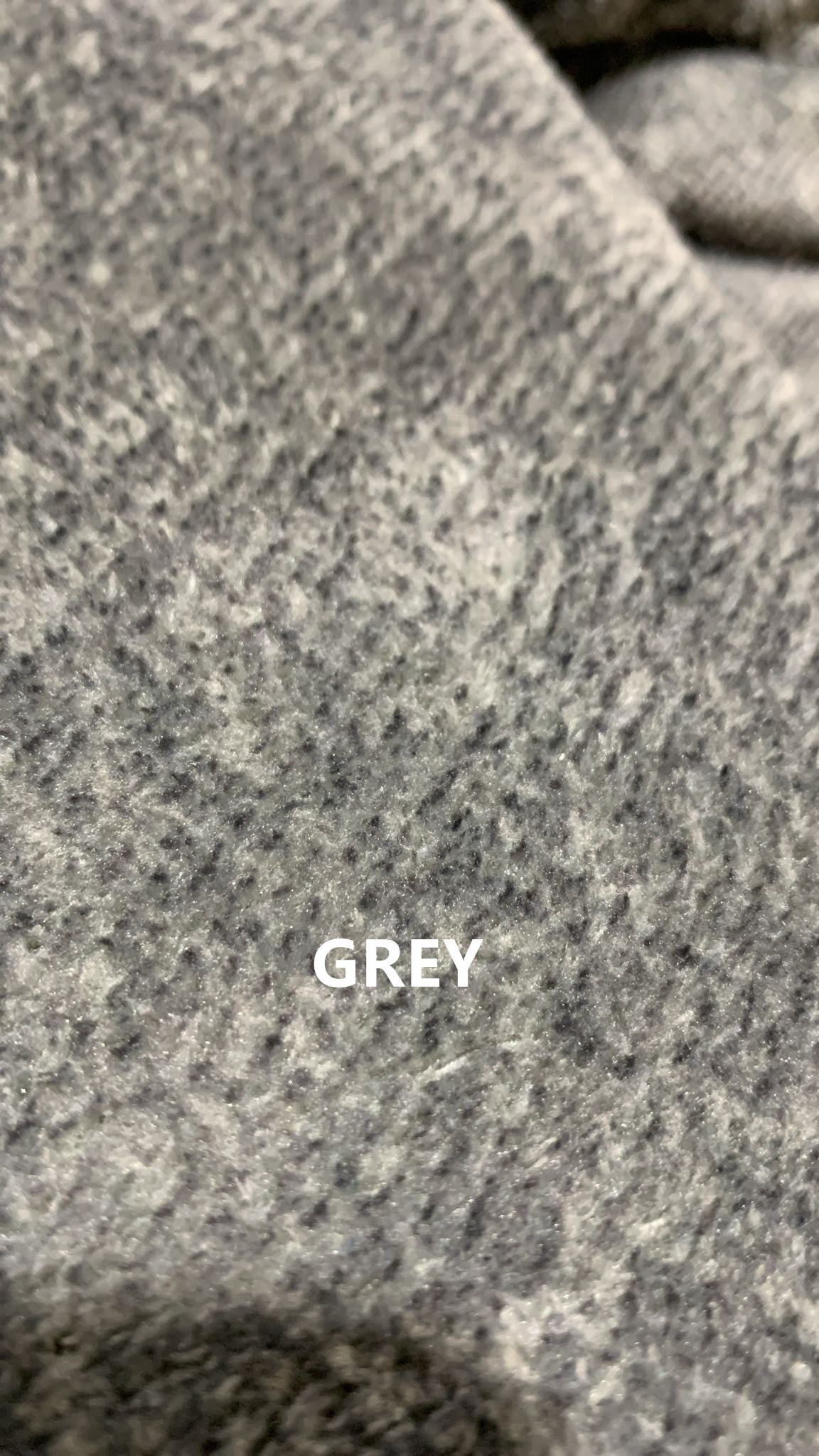Close-up view of grey chenille fabric upholstery on sofa
